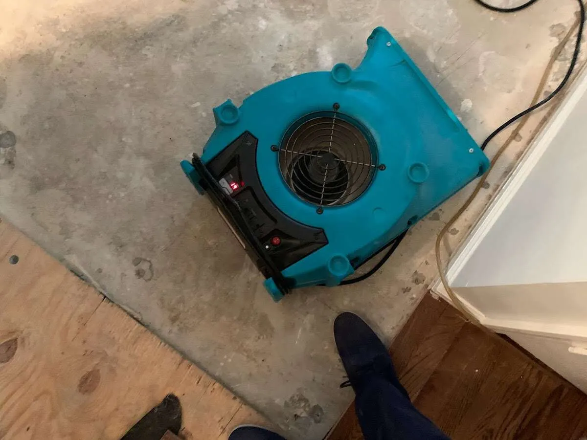 Air mover drying subfloor during Commercial Water Damage Restoration in Stony Point